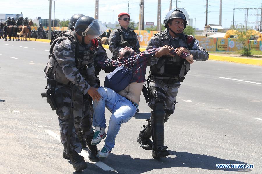 Police arrest a demonstrator during a protest prior to the FIFA's Confederations Cup Brazil 2013 match between Brazil and Mexico, held at Castelao Stadium, in Fortaleza, Brazil, on June 19, 2013. (Xinhua/Alez Silva/AGENCIA O DIA/AGENCIA ESTADO)