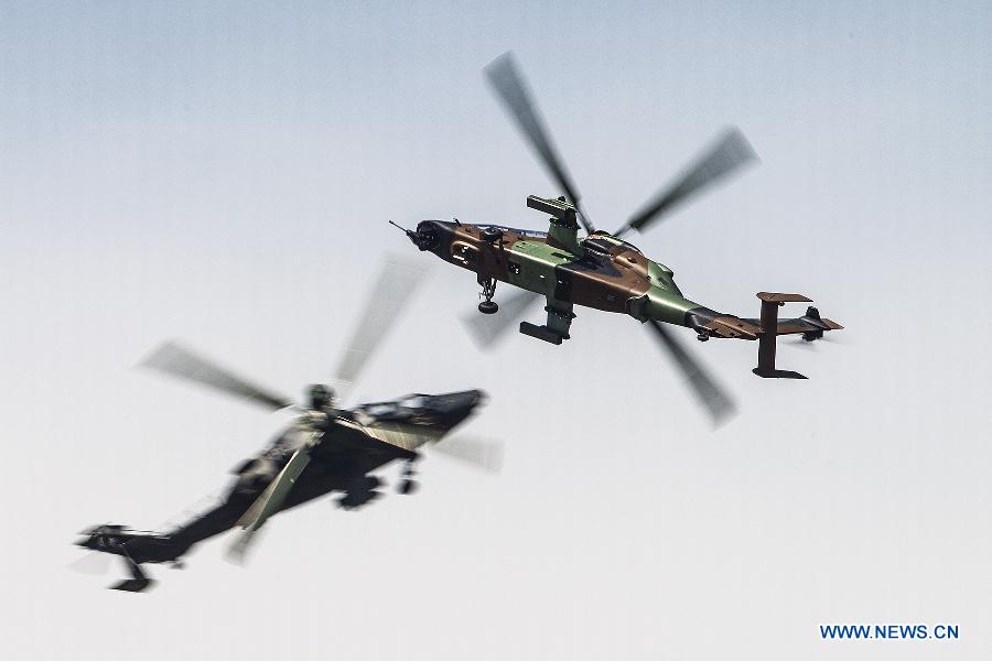Tiger helicopters participate in a flying display during the 50th International Paris Air Show at the Le Bourget airport in Paris, France, June 17, 2013. The Paris Air Show runs from June 17 to 23. (Xinhua/Chen Cheng)
