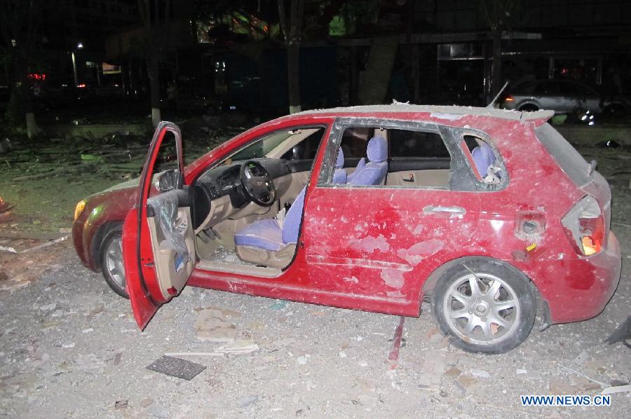 Photo taken on June 19, 2013 shows a damaged car near the blast accident scene at a restaurant in Shuozhou City, north China's Shanxi Province. Blasts ripped through a restaurant in Shuozhou Wednesday night, killing two people and injuring over 150 others. The explosion of natural gas pipes was suspected to be the cause of the accident after an initial investigation. (Xinhua/Lu Xiaoyu)