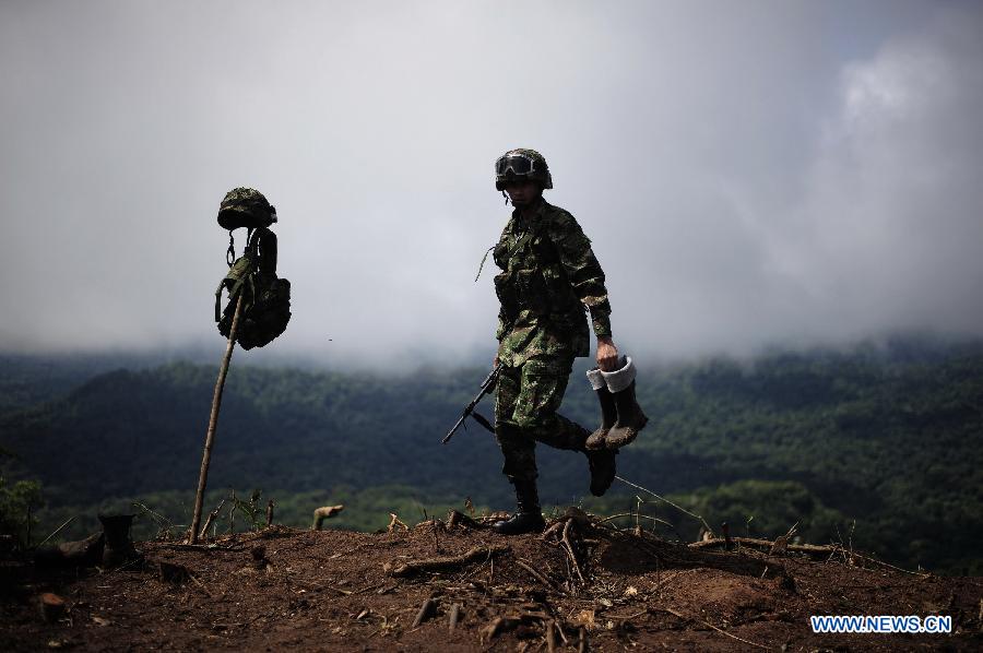 A soldier attends a raid at an illegal coca plantation, in Darien, Panama, on June 18, 2013. Panama National Border Police in conjunction with the Colombian army, found two hectares of illegal coca plantation next to a clandestine cocaine laboratory. Both authorities met on Tuesday to announce a new base in central Darien. The base will enforce security, combat the war on drugs and fight the guerrilla movement on the Panama-Colombia border, according to local press. (Xinhua/Mauricio Valenzuela)