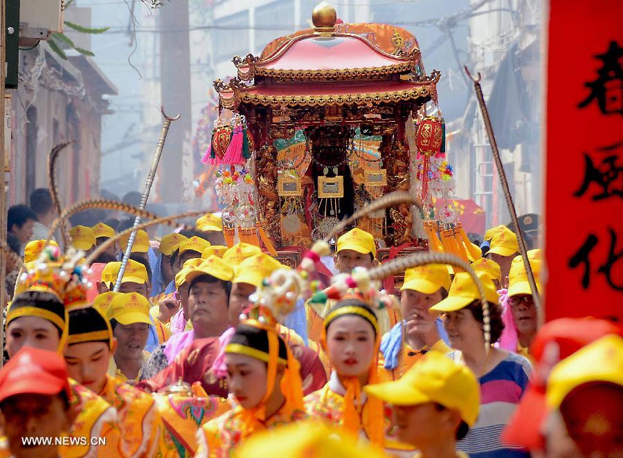 Locals participate in an annual parade honoring Guandi at Tongling Town in Dongshan County, southeast China's Fujian Province, June 20, 2013. Guandi, namely Guan Yu, was a senior general of shu han (221-263) during the three kingdoms period. Guan had been deified by feudal rulers of past ages because of his loyalty to his kingdom and was dubbed "guandi (emperor guan of military strategies)". Guan and confucius, known as the "emperor of education", were usually considered equal in status. (Xinhua/Wang Song) 