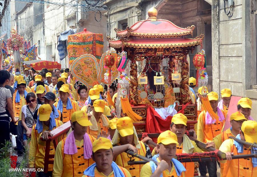 Locals participate in an annual parade honoring Guandi at Tongling Town in Dongshan County, southeast China's Fujian Province, June 20, 2013. Guandi, namely Guan Yu, was a senior general of shu han (221-263) during the three kingdoms period. Guan had been deified by feudal rulers of past ages because of his loyalty to his kingdom and was dubbed "guandi (emperor guan of military strategies)". Guan and confucius, known as the "emperor of education", were usually considered equal in status. (Xinhua/Wang Song) 