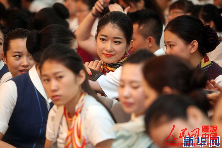 Wearing the uniforms of different airlines, graduates become beautiful landscape at the graduation ceremony on June 19, 2013. (Xinhua/Liu Yuedong)