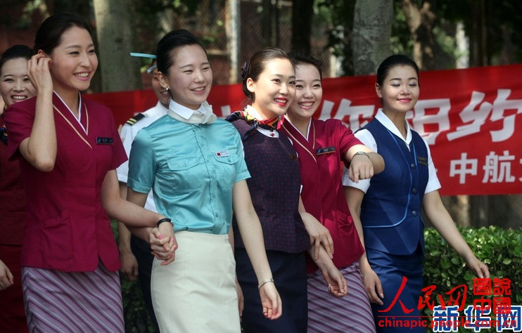 Wearing the uniforms of different airlines, graduates become beautiful landscape at the graduation ceremony on June 19, 2013. (Xinhua/Liu Yuedong)