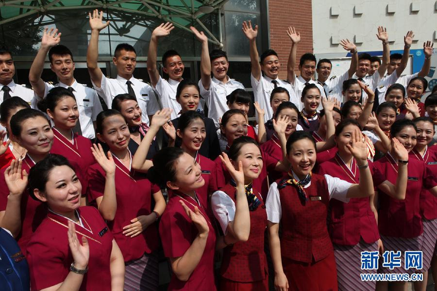 Wearing the uniforms of different airlines, graduates pose for photo on campus on June 19, 2013. (Xinhua/Liu Yuedong)