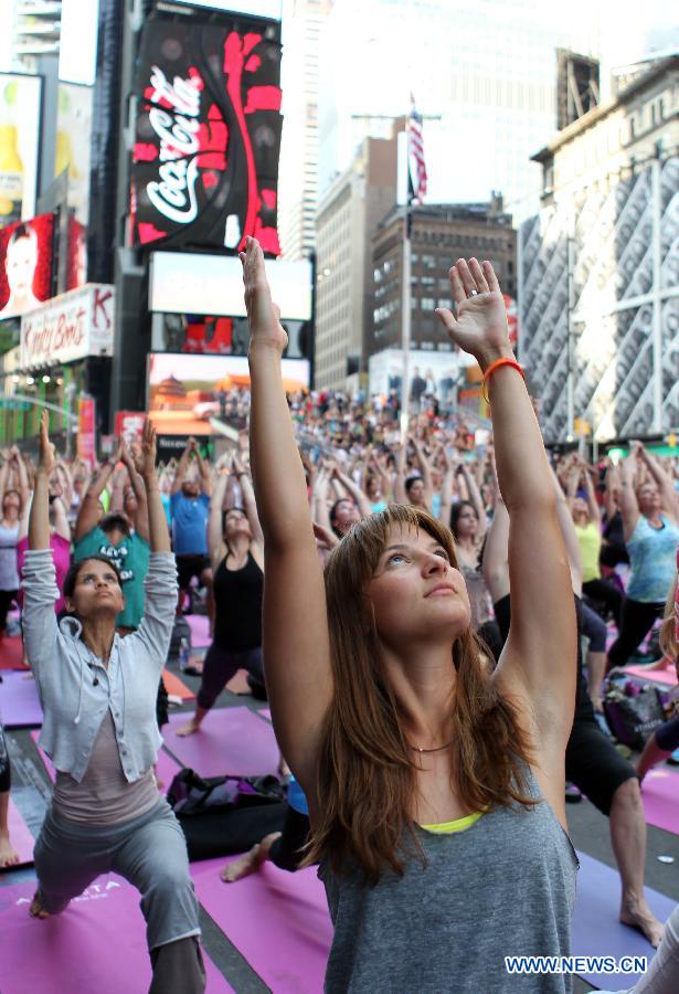 Yoga enthusiasts practice yoga during the "Solstice in Times Square" event at Times Square in New York, the United States, June 21, 2013. Thousands of yoga enthusiasts came here to do yoga in celebration of the longest day of the year. (Xinhua/Cheng Li) 