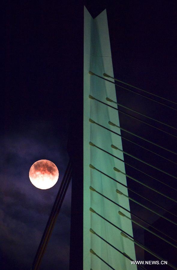 A super moon hangs in the sky over Rotterdam, the Netherlands, on June 22, 2013. On Saturday a perigee moon coincided with a full moon creating a "super moon" when it passed by the earth at its closest point in 2013. (Xinhua/Robin Utrecht)