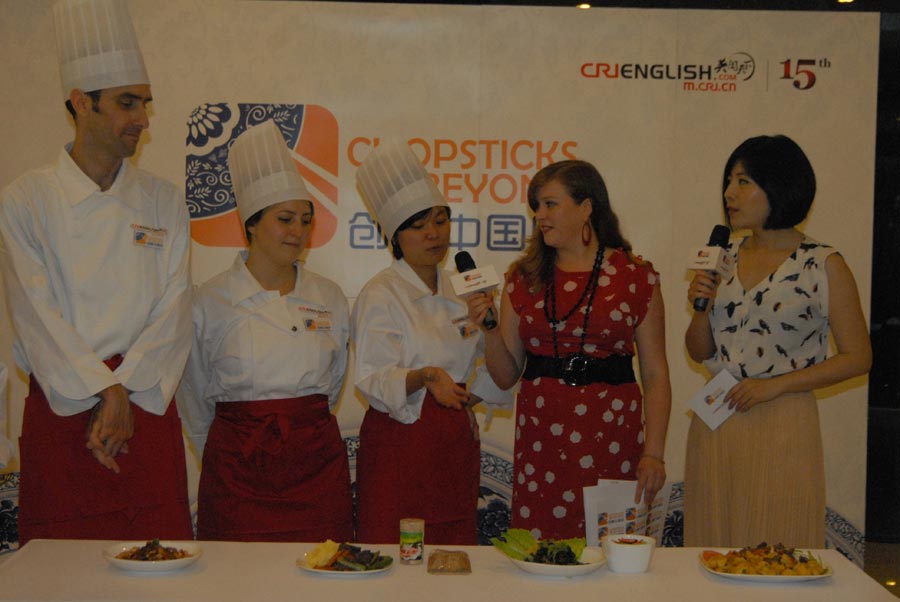 Ying Si from Thailand shows her winning “Sichuan Beef and Salad” at the "Chopsticks and Beyond" Sichuan Cuisine Competition, in Beijing, June 22, 2013. "Chopsticks and Beyond" is a Chinese cuisine challenge launched by CRIENGLISH.com to provide a platform for foreign food enthusiasts to show off their Chinese cooking skills and explore creative dishes with exotic flavor. It features China's four great traditions: Sichuan Cuisine, Cantonese Cuisine, Shandong Cuisine and Huaiyang Cuisine.(Xinhuanet/Yang Yi)