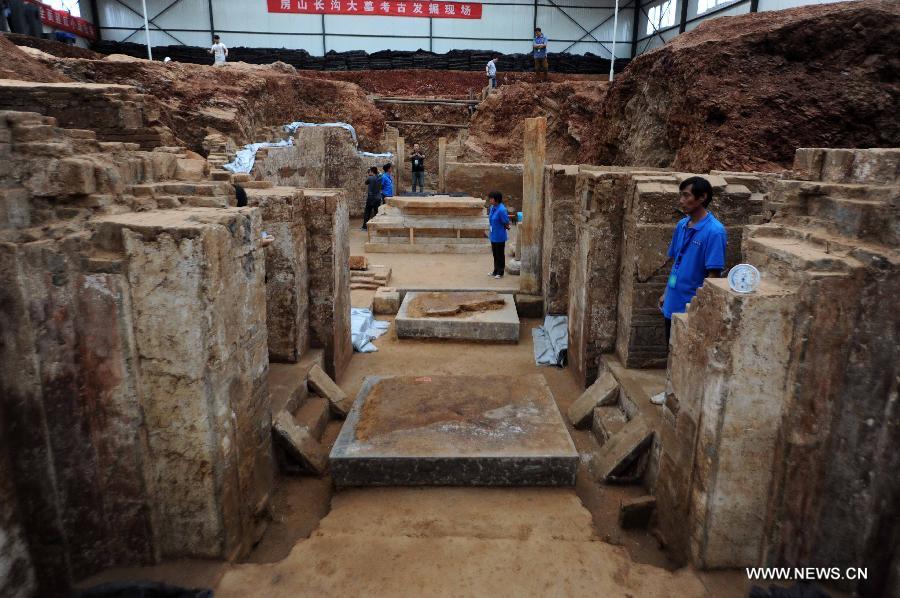 Photo taken on June 22, 2013 shows the archeological site of an ancient tomb in Fangshan District of Beijing, capital of China. A gravestone excavated from the tomb confirmed that the tomb was the final resting place of Liu Ji, a regional military governor of the Tang Dynasty (618-907), and his wife. Archaeologists have started a salvage excavation of the tumulus since August 2012, after it was accidentally discovered at a local construction site. Valuable cultural relics, including an exquisite stone coffin bed, were discovered. (Xinhua/Luo Xiaoguang)