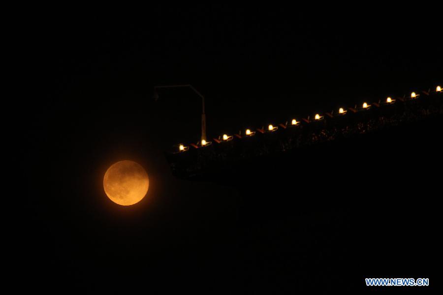 A full moon is seen in Beijing, capital of China, June 23, 2013. The moon looks 14 percent larger and 30 percent brighter than usual on Sunday. The scientific term for the phenomenon is "perigee moon", but it is also known as a "super moon". (Xinhua/Xing Guangli)