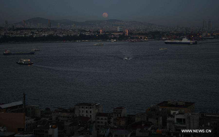 The moon is seen in the sky over Istanbul on June 23, 2013. On Sunday, a perigee moon coincided with a full moon creating a "super moon" when it passed by the earth at its closest point in 2013. (Xinhua/Lu Zhe)