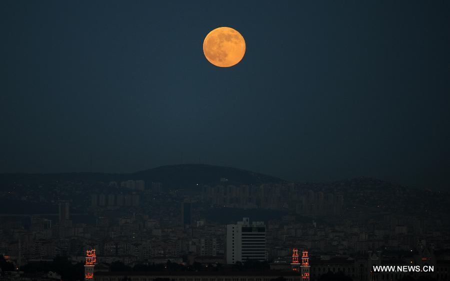 The moon is seen in the sky over Istanbul on June 23, 2013. On Sunday, a perigee moon coincided with a full moon creating a "super moon" when it passed by the earth at its closest point in 2013. (Xinhua/Lu Zhe)