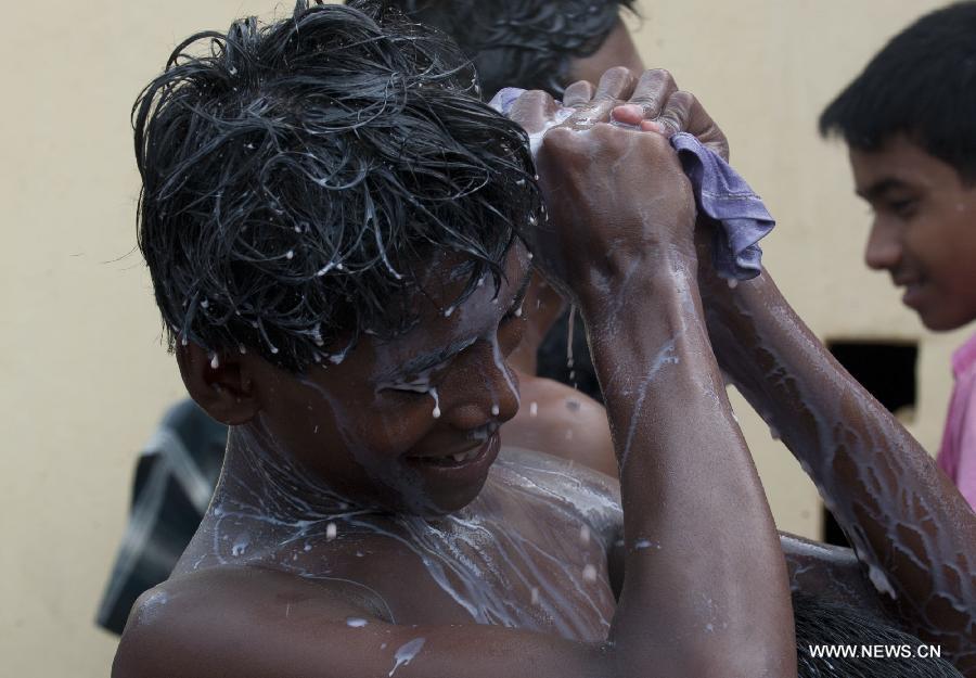 An Indian devotee bathes with milk during the holy bathing ceremony of Lord Jagannath at a temple near Calcutta, capital of eastern Indian state West Bengal, on June 23, 2013. (Xinhua/Tumpa Mondal) 