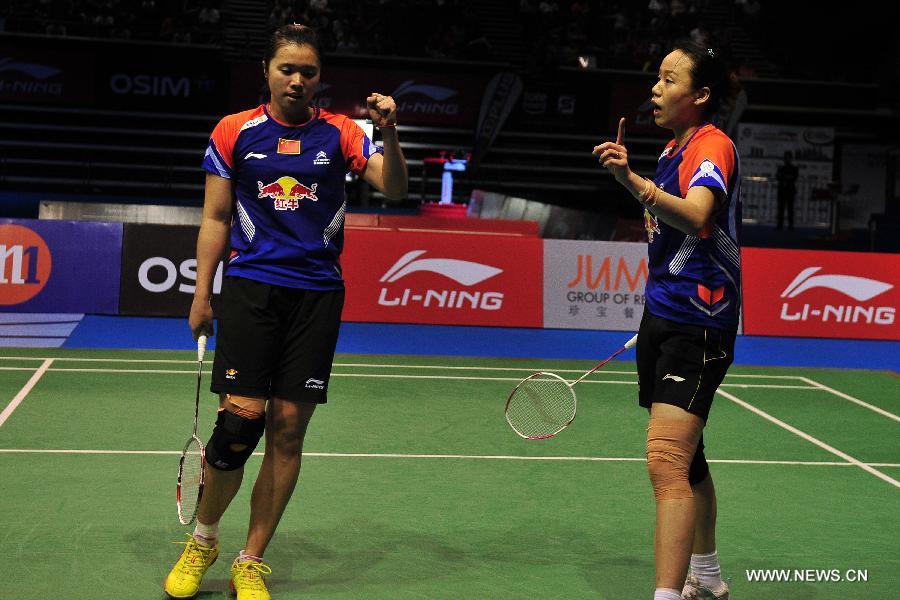 Zhao Yunlei (R) and Tian Qing of China react during their women's doubles finals against Misaki Matsutomo and Ayaka Takahashi of Japan in the Singapore Open badminton tournament in Singapore, June 23, 2013. Zhao Yunlei and Tian Qing won 2-0. (Xinhua/Then Chih Wey)