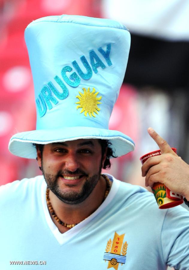 A fan of Uruguay reacts prior the FIFA's Confederations Cup Brazil 2013 match against Tahiti, held at Arena Pernambuco Stadium, in Recife, Pernambuco state, Brazil, on June 23, 2013. (Xinhua/Weng Xinyang)