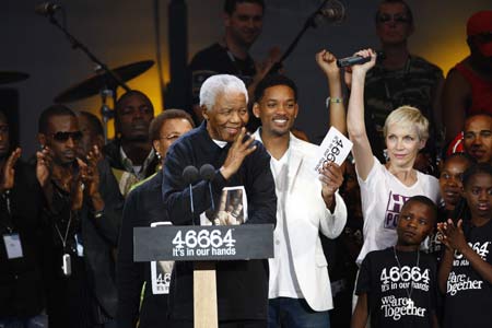 Former South African President Nelson Mandela (Front) waves during the 46664 concert held in his honour in Hyde Park, London June 27, 2008. The event was organized to raise funds for Nelson Mandela's HIV/AIDS "46664" campaign, named after his prison number. Exactly 46,664 people were expected to attend the event, which also celebrates the former South African president's 90th birthday on July 18. (Xinhua/Reuters Photo)