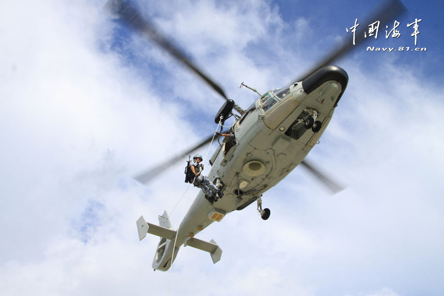 A special operation detachment under a marine brigade of the Chinese People's Liberation Army Navy (PLAN) conducts a joint escorting training with a landing ship flotilla of the PLAN on the high-risk subjects, such as climbing boarding, cabin search, sea blockade and arresting pirates. (China Military Online/ Sun Haichao and Jiang Zhengyuan)