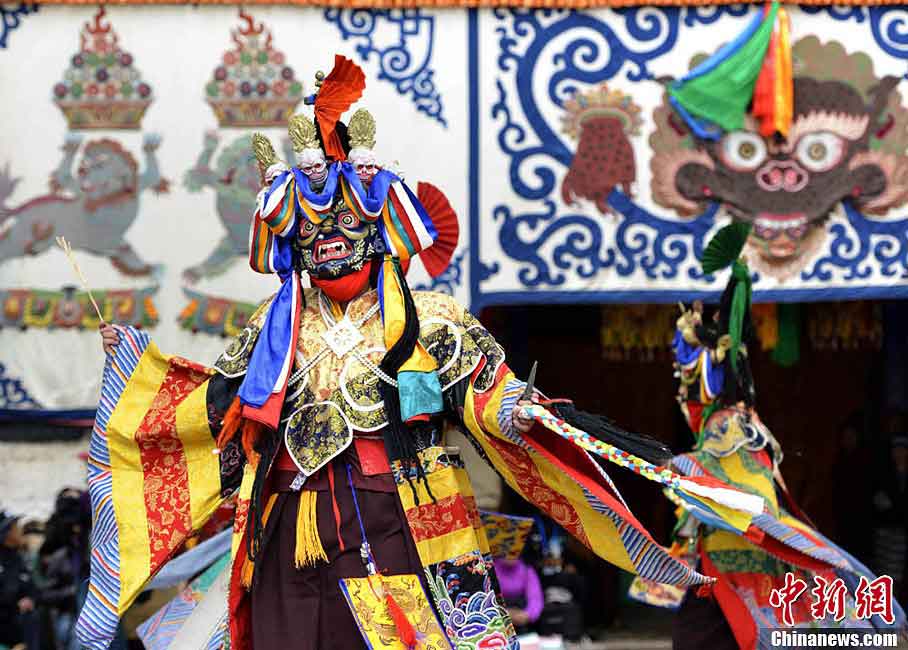 Lamas wearing masks perform "Qiang Mu" dance in Samye Monastery in Chanang County, Southwest China's Tibet Autonomous Region, June 24, 2013. "Qiang Mu," a religious dance of Tibetan Buddhism, is a well-established performing art form combining scripture chanting in perfect unison with music and dance, and performed in temples by lamas with solemn and splendid atmospheres. (CNS/Li Lin)