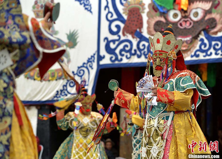 Lamas wearing masks perform "Qiang Mu" dance in Samye Monastery in Chanang County, Southwest China's Tibet Autonomous Region, June 24, 2013. "Qiang Mu," a religious dance of Tibetan Buddhism, is a well-established performing art form combining scripture chanting in perfect unison with music and dance, and performed in temples by lamas with solemn and splendid atmospheres. (CNS/Li Lin)