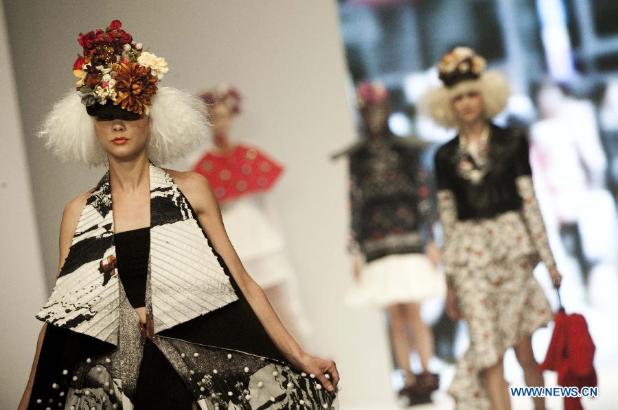 Models present creations by graduates from the Institute of Textiles and Clothing in Hong Kong Polytechnic University during their graduation show in Hong Kong, south China, June 26, 2013. (Xinhua/Lui Siu Wai)