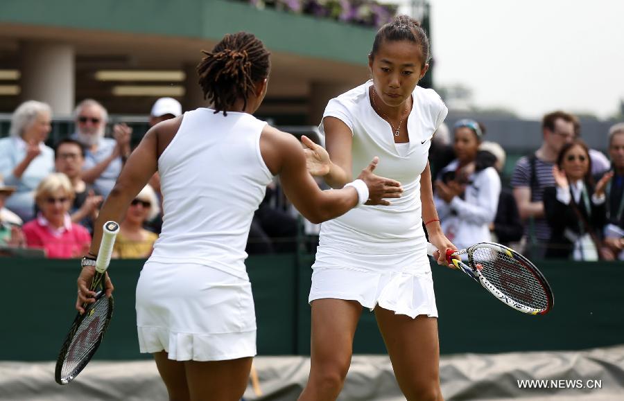 Zhang Shuai (R) of China and Megan Moulton-Levy of the United States clap hands during the first round of ladies' doubles against Mona Barthel of Germany and Liga Dekmeijere of Latvija on day 3 of the Wimbledon Lawn Tennis Championships at the All England Lawn Tennis and Croquet Club in London, Britain on June 26, 2013. Moulton-Levy and Zhang won 2-1.(Xinhua/Wang Lili)