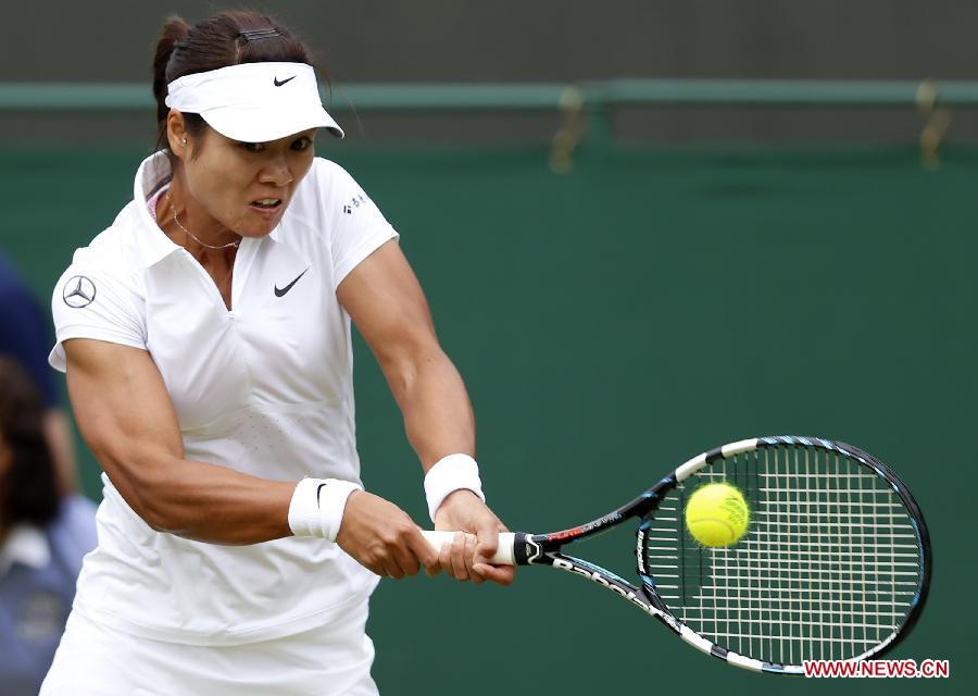 Li Na of China returns the ball during the second round of ladies' singles against Simona Halep of Romania on day 4 of the Wimbledon Lawn Tennis Championships at the All England Lawn Tennis and Croquet Club in London, Britain on June 27, 2013. Li won 2-1. (Xinhua/Yin Gang)