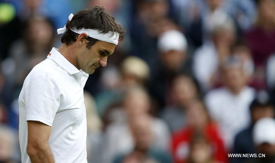 Roger Federer of Switzerland reacts during the second round of men's singles against Sergiy Stakhovsky of Ukraine on day 3 of the Wimbledon Lawn Tennis Championships at the All England Lawn Tennis and Croquet Club in London, Britain, on June 26, 2013. Roger Federer lost 1-3. (Xinhua/Yin Gang)