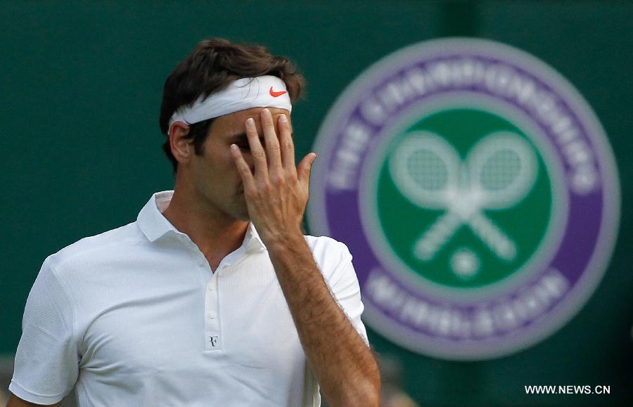 Roger Federer of Switzerland reacts during the second round of men's singles against Sergiy Stakhovsky of Ukraine on day 3 of the Wimbledon Lawn Tennis Championships at the All England Lawn Tennis and Croquet Club in London, Britain, on June 26, 2013. Roger Federer lost 1-3. (Xinhua/Yin Gang)