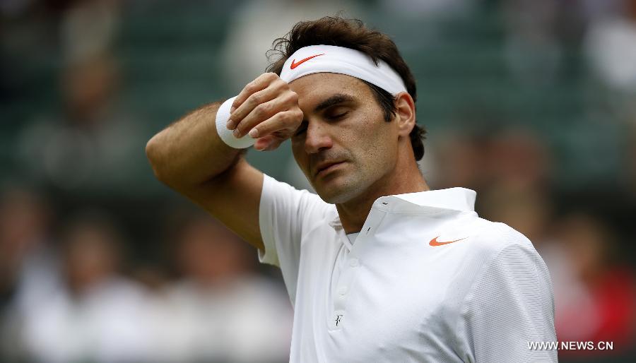 Roger Federer of Switzerland reacts during the second round of men's singles against Sergiy Stakhovsky of Ukraine on day 3 of the Wimbledon Lawn Tennis Championships at the All England Lawn Tennis and Croquet Club in London, Britain, on June 26, 2013. Roger Federer lost 1-3. (Xinhua/Yin Gang)