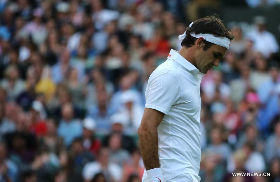 Roger Federer of Switzerland reacts during the second round of men's singles against Sergiy Stakhovsky of Ukraine on day 3 of the Wimbledon Lawn Tennis Championships at the All England Lawn Tennis and Croquet Club in London, Britain, on June 26, 2013. Roger Federer lost 1-3. (Xinhua/Yin Gang)