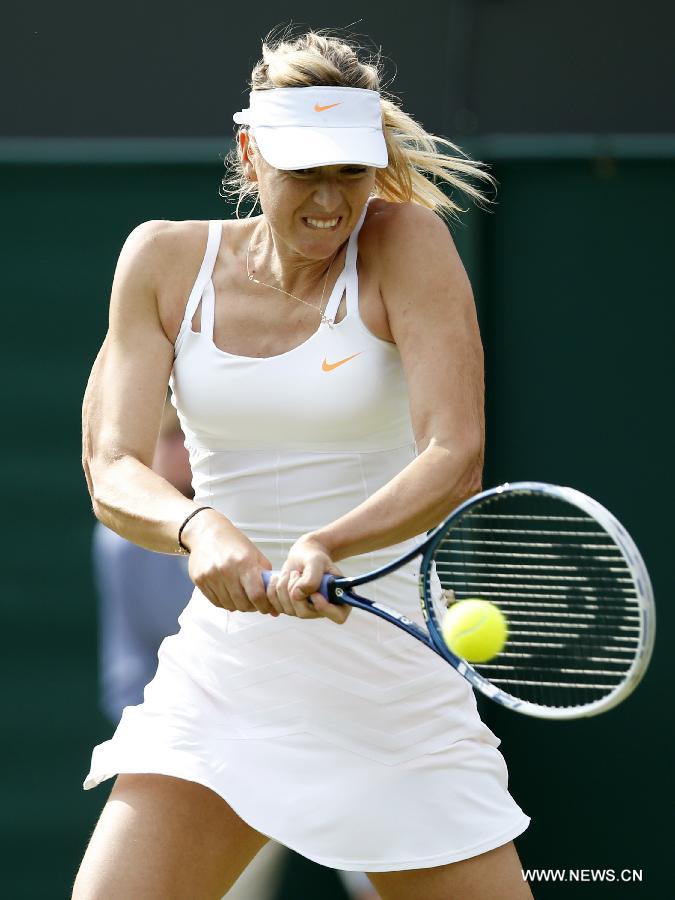 Maria Sharapova of Russia reacts during the second round of women's singles against Michelle Larcher De Brito of Portugal on day 3 of the Wimbledon Lawn Tennis Championships at the All England Lawn Tennis and Croquet Club in London, Britain on June 26, 2013. Maria Sharapova lost 0-2.(Xinhua/Wang Lili)