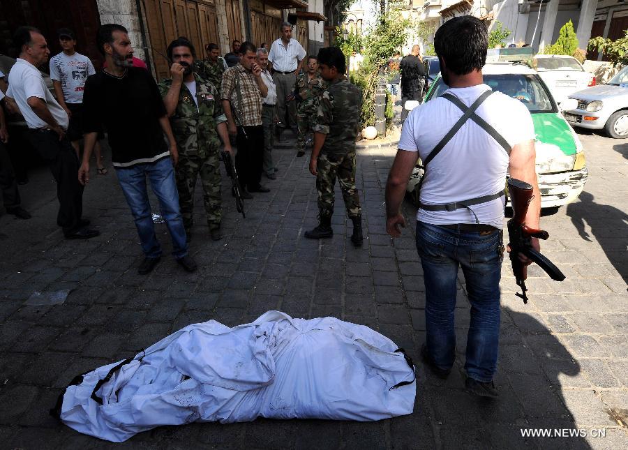 Security members stand guard near the site of blast in Damascus, capital of Syria, on June 27, 2013. At least four people were killed and many others wounded when a suicide bombing struck near the Mariamieh Patriarchate in the old quarter of the Syrian capital Damascus on Thursday, local media said. (Xinhua/Zhang Naijie) 