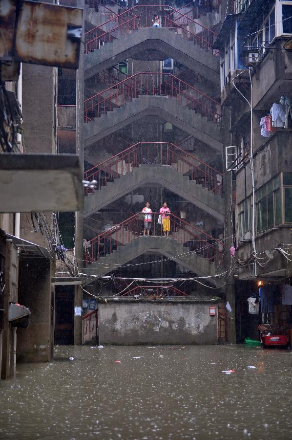 A building stands on a flooded road in Nanchang, capital of east China's Jiangxi Province, June 28, 2013. Heavy rainfall hit the city on Friday. (Xinhua/Zhou Mi) 