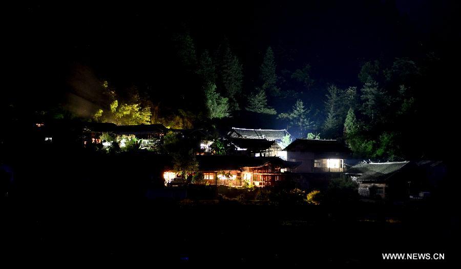 Photo taken on June 26, 2013 shows the evening scenery of stilted buildings at Jinlongba Village in Enshi City, central China's Hubei Province. The Jinlongba Village was listed among the 646 Chinese Traditional Villages in 2012 and villagers here followed the traditional way of living. (Xinhua/Yang Shunpi)  