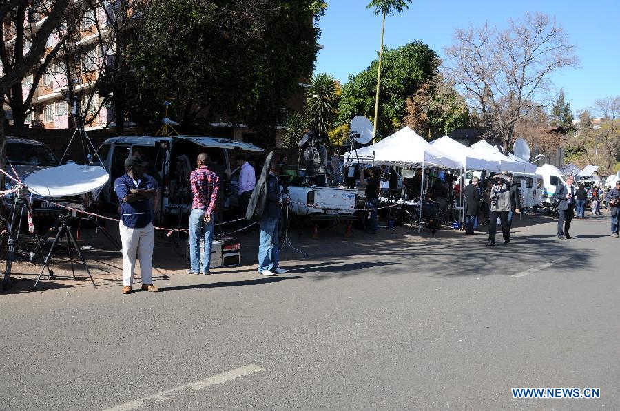 Media vehicles, tents and equipments are seen outside the hospital where South Africa's anti-apartheid icon Nelson Mandela gets medical treatment in Pretoria, South Africa, on June 28, 2013. Mandela's condition continues to improve, Mandela's ex-wife Winnie Madikizela-Mandela said on Friday. (Xinhua/Guo Xinghua) 