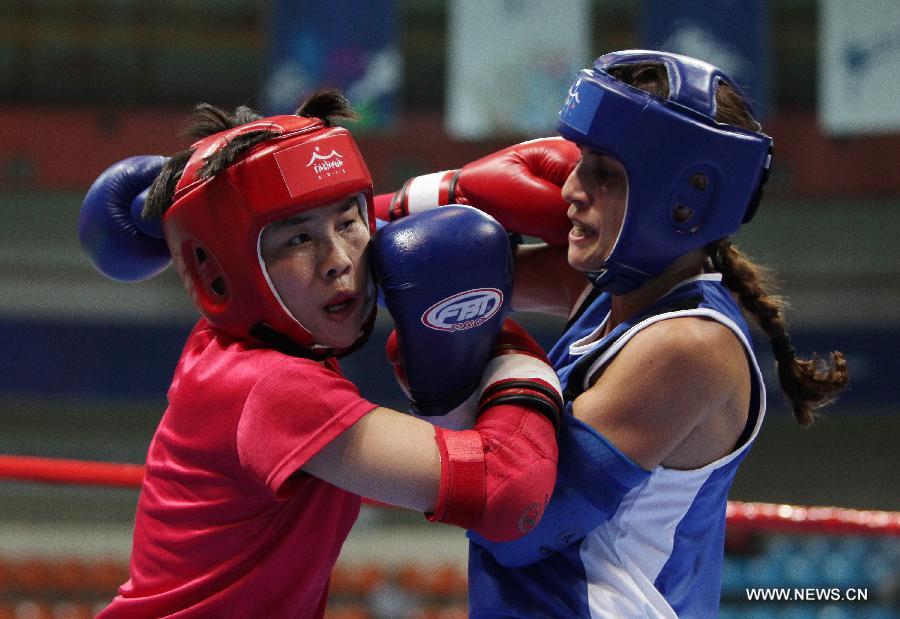 Yuan Xiaoyan (L) of China and Aoun Anita of Lebanon compete during their Muay women's 51kg quarterfinal fight during the 4th Asian Indoor and Martial Arts Games (AIMAG) in Incheon, South Korea, June 30, 2013. Yuan Xiaoyan won 5-0. (Xinhua/Park Jin-hee)