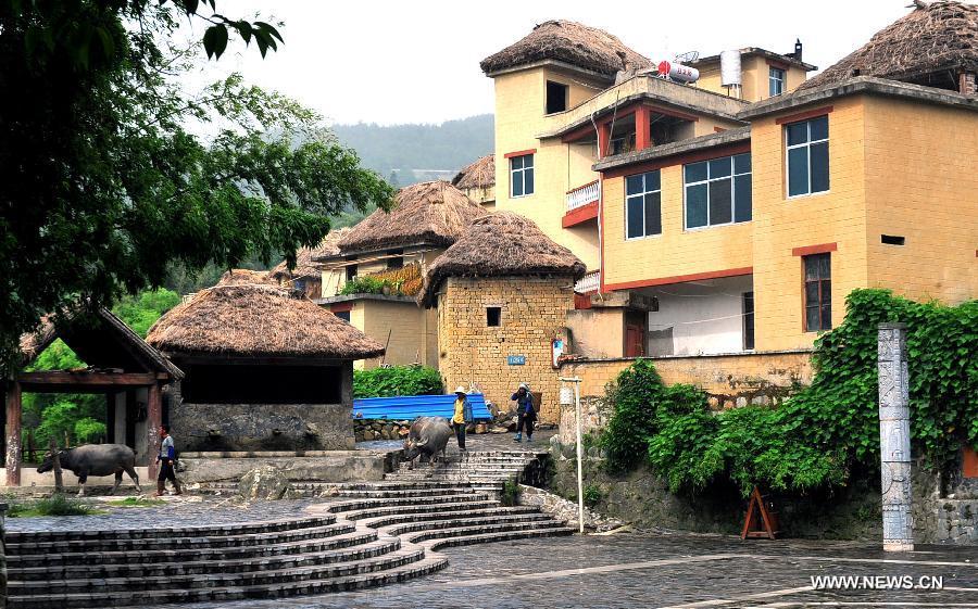 Photo taken on June 29, 2013 shows the village buildings in Yuanyang County of Honghe Prefecture in southwest China's Yunnan Province. The UNESCO's World Heritage Committee inscribed China's cultural landscape of Honghe Hani Rice Terraces onto the prestigious World Heritage List on June 22, bringing the total number of World Heritage Sites in China to 45. (Xinhua/Chen Haining)