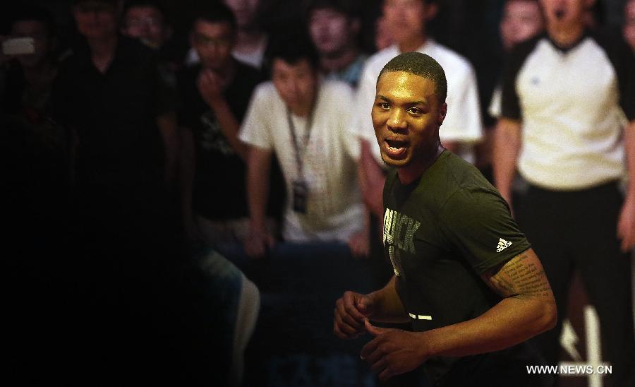 NBA star Damian Lillard from Portland Trail Blazers celebrates after scoring during a business event in Beijing, capital of China, June 30, 2013. Four NBA stars Jrue Holiday from Philadelphia 76ers, Ricky Rubio from Minnesota Timberwolves, Damian Lillard from Portland Trail Blazers and John Wall from Washington Wizards shared their basketball skills and funs with Chinese fans during a business event in Beijing on Sunday. (Xinhua/Li Ming)