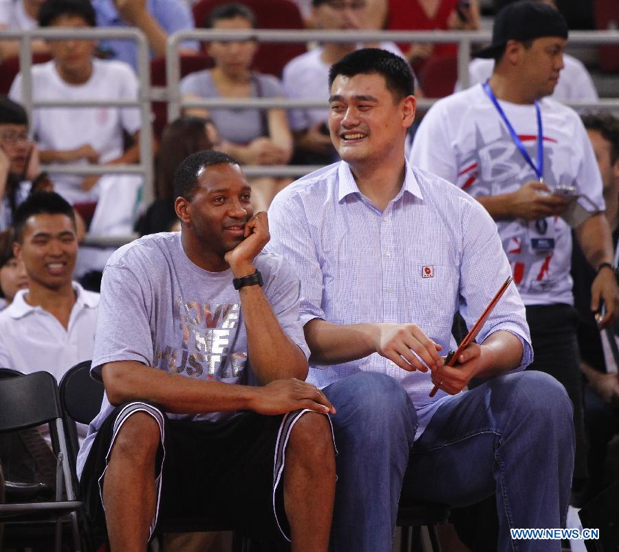 Yao Ming (R) and NBA star Tracy McGrady watch a Yao Foundation Charity Game, sponsored by the charity foundation initiated by former Chinese basketball star Yao Ming, between the Chinese team and a team of NBA stars in Beijing, China, July 1, 2013. (Xinhua/Ding Xu)