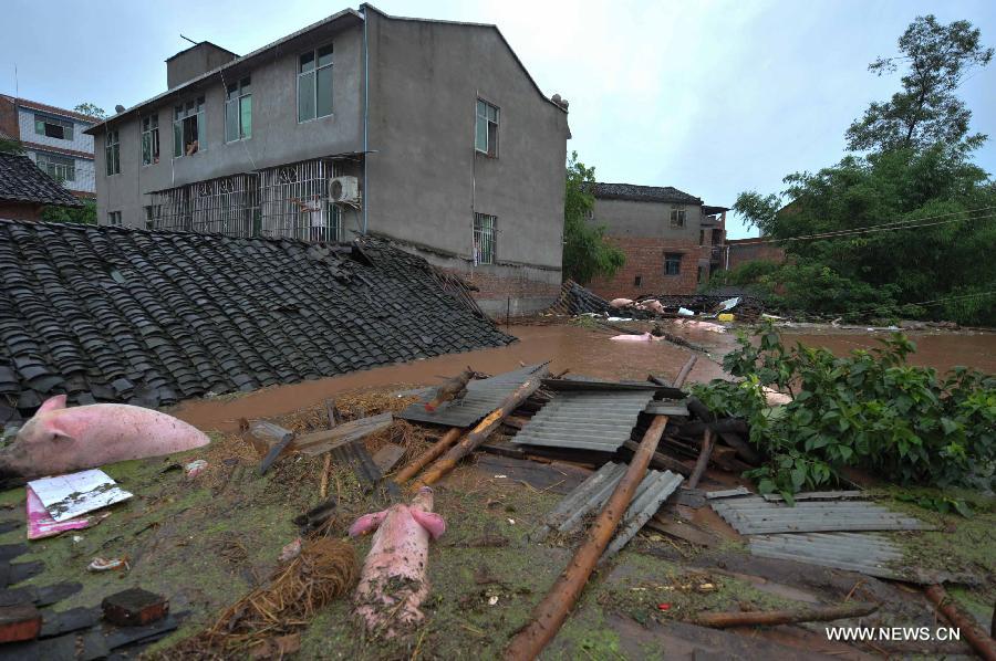 Submerged buildings are seen at Baizi Town in Tongnan County of Chongqing, southwest China, July 1, 2013. Rainstorms swept the county Sunday and triggered serious flood. As of 3 p.m. Monday, more than 18,000 people had been evacuated in Tongnan, and authorities were still working to confirm the number of casualties, as well as the number of people trapped by the floods. (Xinhua/Liu Chan)