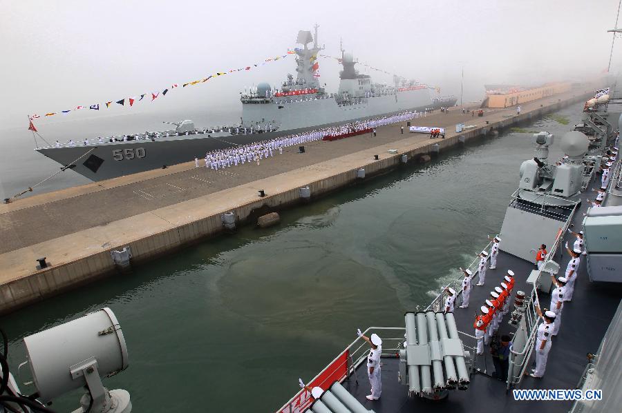 Officers and soldiers of Chinese navy take part in a ceremony for the departure of a fleet in the port of Qingdao, east China's Shandong Province, July 1, 2013. A Chinese fleet consisting of seven naval vessels departed from east China's harbor city of Qingdao on Monday to participate in Sino-Russian joint naval drills scheduled for July 5 to 12. The eight-day maneuvers will focus on joint maritime air defense, joint escorts and marine search and rescue operations. (Xinhua/Zha Chunming)