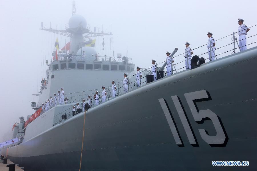 Officers and soldiers of Chinese navy stand on the destroyer Shenyang during a ceremony for the departure of a fleet in the port of Qingdao, east China's Shandong Province, July 1, 2013. A Chinese fleet consisting of seven naval vessels departed from east China's harbor city of Qingdao on Monday to participate in Sino-Russian joint naval drills scheduled for July 5 to 12. The eight-day maneuvers will focus on joint maritime air defense, joint escorts and marine search and rescue operations. (Xinhua/Zha Chunming)