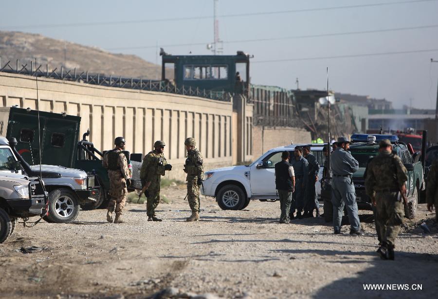 Afghan soldiers stand guard at the site of attack in Kabul, Afghanistan, on July 2, 2013. Twelve people including, five Taliban suicide bombers, four Nepalese contractor guards, one Afghan guard and two civilians, were killed in the attack, officials said. (Xinhua/Ahmad Massoud)