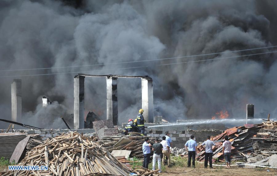 Firemen spray water to control a fire at a warehouse near the Changsha South Railway Station in Changsha, capital of central China's Hunan Province, July 2, 2013. A fire engulfed the warehouse Sunday without injuring anyone. Local fire department took more than two hours to douse the fire. (Xinhua/Li Ga) 