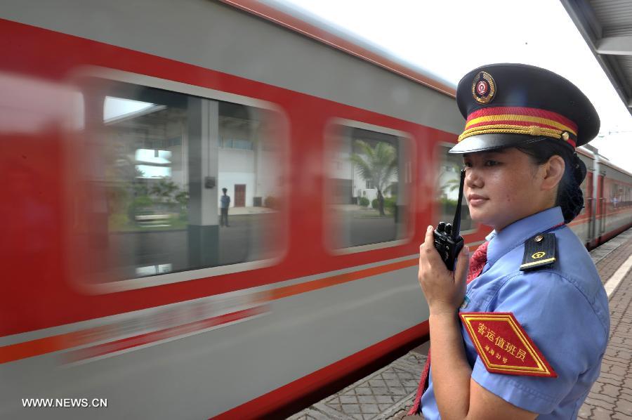 A staff member watches the first direct train from Haikou to Harbin leaving the Haikou Railway Station in Haikou, capital of south China's Hainan Province, July 2, 2013. The train K1122/3 from south China's Haikou to northeast China's Heilongjiang left Haikou Tuesday, a day later than its original departure date due to the tropical storm Rumbia. The train which travels 4,458 kilometers for 65 hours has connected China's southernmost capital city Haikou of Hainan Province with China's northernmost capital city Harbin of Heilongjiang Province. (Xinhua/Zhao Yingquan)