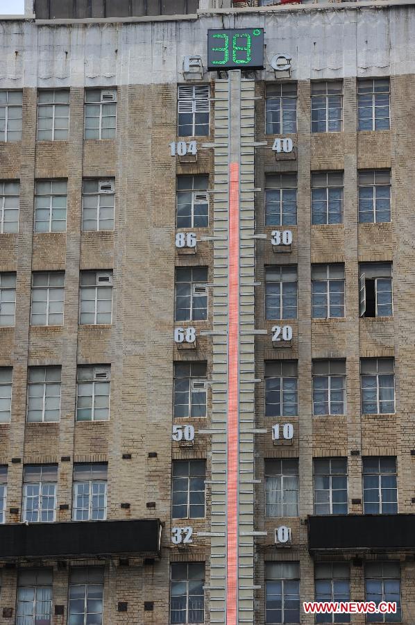 A giant thermometer indicates the temperature on a building at the Nanjing Road in Shanghai, east China, July 2, 2013. Shanghai meteorological bureau issued an orange-coded heat alert Tuesday, as parts of the city have been under the highest temperature of 38 degrees Celsius. (Xinhua/Lai Xinlin) 