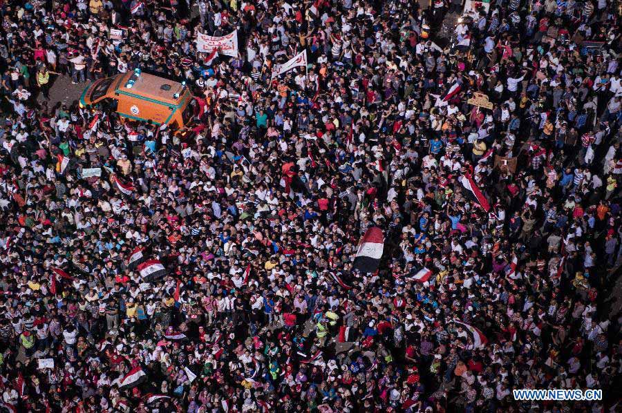 An ambulance is seen among anti-President Mohamed Morsi protesters at Cairo's Tahrir Square, Egypt, July 2, 2013. Egyptian President Mohamed Morsi said late Tuesday that there will be no alternative for "constitutional legitimacy," amid the ongoing political division in his country, where the opposition and liberal are asking him to quit power. (Xinhua/Li Muzi)