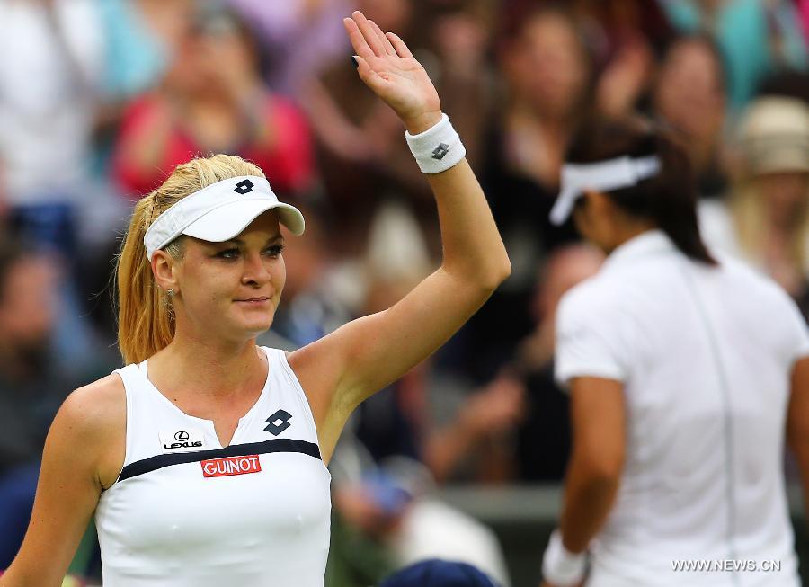 Agnieszka Radwanska (L) of Poland reacts after the quarterfinal of women's singles against Li Na of China on day 8 of the Wimbledon Lawn Tennis Championships at the All England Lawn Tennis and Croquet Club in London, Britain on July 2, 2013. Agnieszka Radwanska won 2-1. (Xinhua/Yin Gang) 