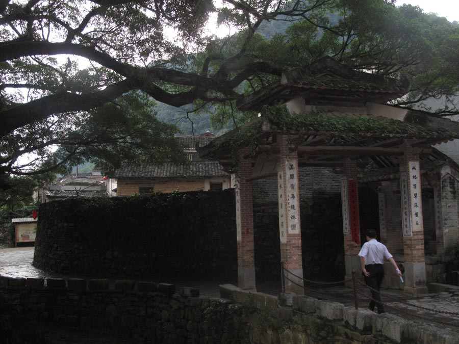 A tourist walks along the stone street. (CnDG by Jiao Meng)