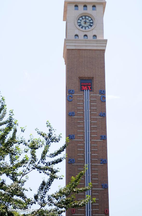 A thermometer on a bell tower reads 36 degrees celsius in Shijiazhuang, capital of north China's Hebei Province, July 3, 2013. The highest temperatures in many parts of Hebei reached 37 degrees celsius on Wednesday. (Xinhua/Wang Xiao)